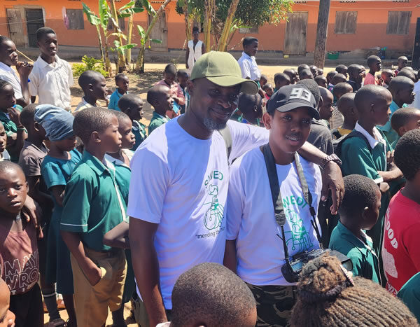 Giving out scholastic materials Kiwawu Church of Uganda Primary School