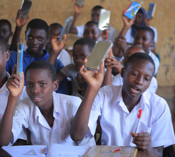 Giving out scholastic materials Kiwawu Church of Uganda Primary School